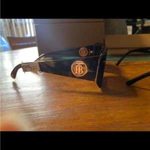 Small square tortoise brown Burberry sunglasses w/ the gold details.